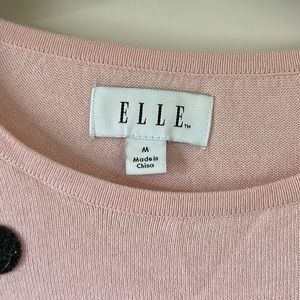 Pink sweater with black sequin button like things on them.Elle medium